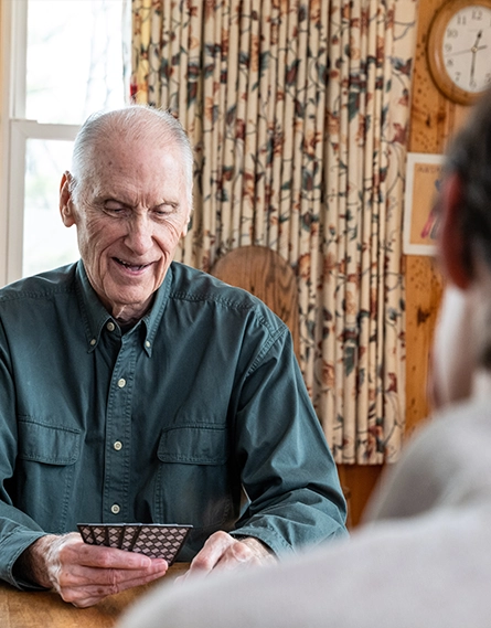 Photo of a patient, Tom playing a card game (photo)